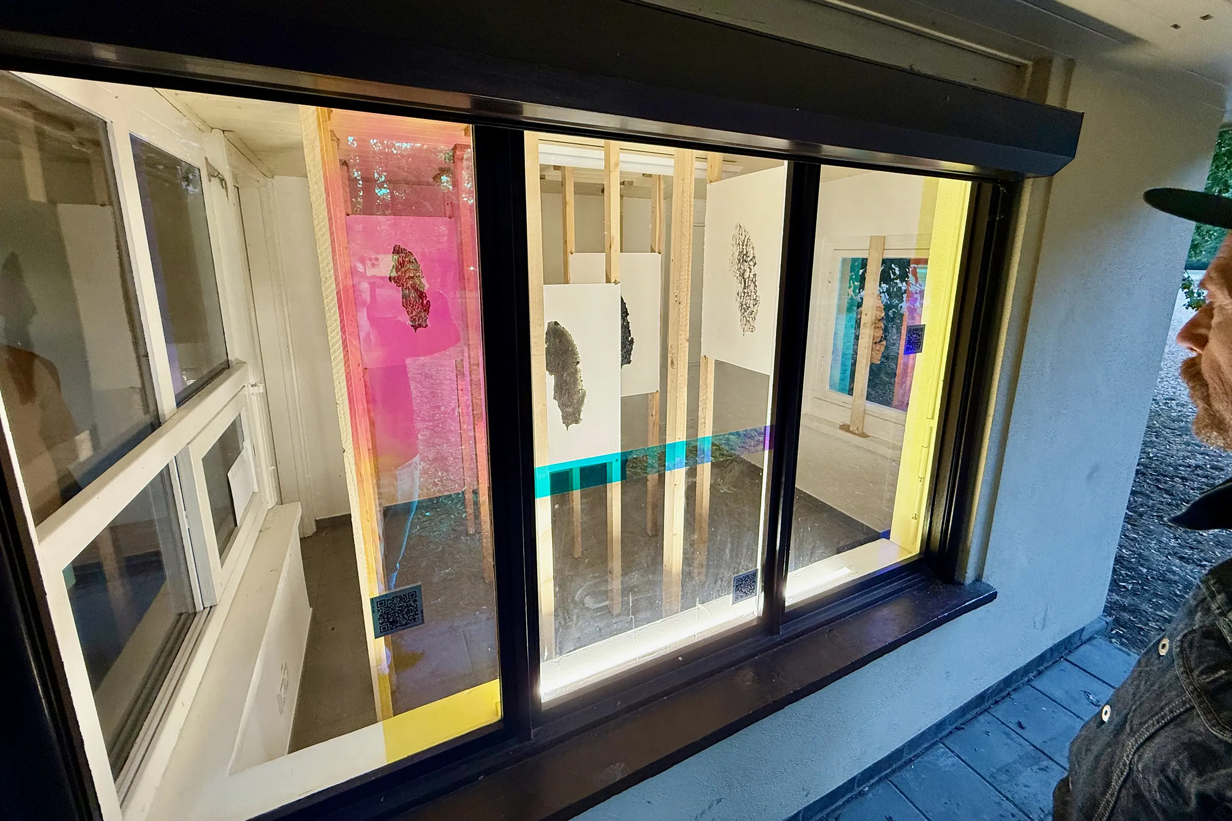 Close view of the windows; a visitor looks into the interior.